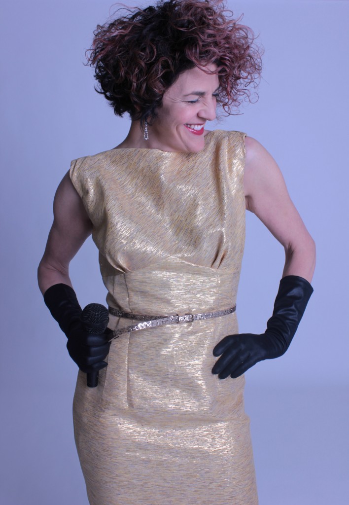 Vintage woven gold gown with black opera gloves.